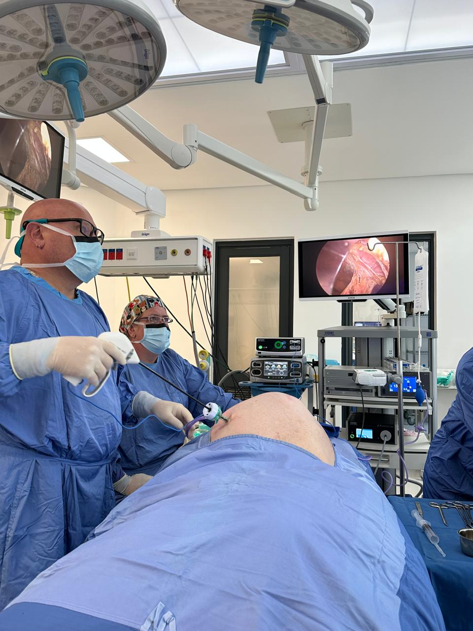 Surgeons working with laparoscopic instruments through small port incisions